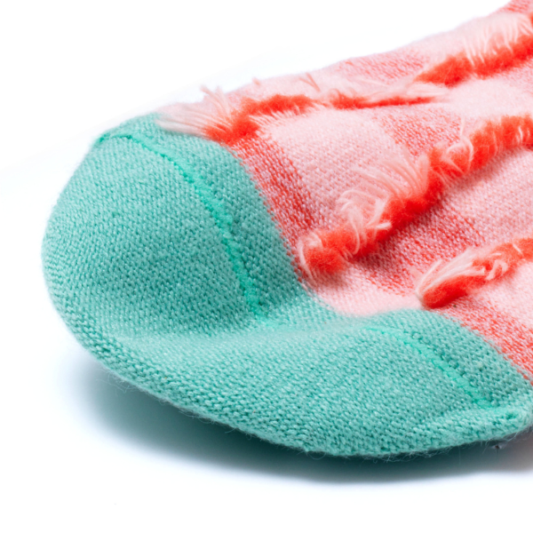 Zoom sur la couture plate et les motifs intérieurs des chaussettes sans couture damier rouge et vert