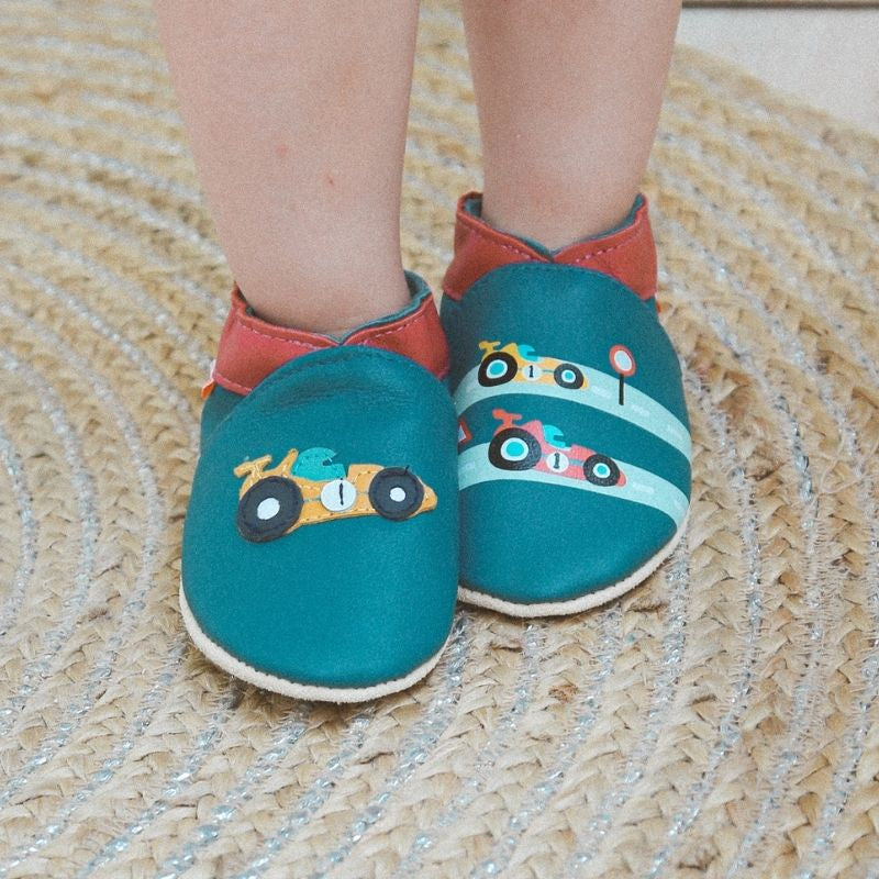Chaussons bébé cuir souple Valentin la formule 1 portés par un enfant